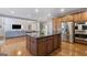 Open-concept kitchen with dark granite island, stainless steel appliances, and hardwood flooring at 301 Dunstans Pass, Marietta, GA 30066