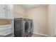 Laundry room equipped with shelving and gray washer and dryer set at 301 Dunstans Pass, Marietta, GA 30066