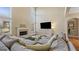 Comfortable living room with a fireplace, large windows, and a plush sectional sofa at 301 Dunstans Pass, Marietta, GA 30066