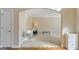 View of carpeted sitting room through arched entryway features neutral paint and modern decor at 301 Dunstans Pass, Marietta, GA 30066