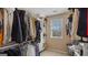 Spacious walk-in closet with custom shelving, hanging rods, and a window for natural light at 301 Dunstans Pass, Marietta, GA 30066