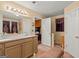 Double vanity bathroom with access to other rooms at 5899 Meadow Ln, Rex, GA 30273
