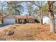 Tan house with two car garage and landscaping at 5899 Meadow Ln, Rex, GA 30273