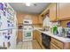 Galley style kitchen with white appliances at 5899 Meadow Ln, Rex, GA 30273