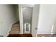 View of carpeted stairs leading to a finished basement with neutral paint and a white door at 60 Sweet Bay Ln, Carrollton, GA 30116