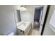 Bathroom featuring a single sink vanity, overhead lighting and access to additional rooms at 60 Sweet Bay Ln, Carrollton, GA 30116