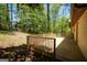 Exterior showing a large wooden deck surrounded by trees and a grassy lawn at 60 Sweet Bay Ln, Carrollton, GA 30116