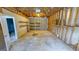 Unfinished garage with exposed framing, shelving and cement floor at 60 Sweet Bay Ln, Carrollton, GA 30116