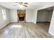 Bright living room featuring a stone fireplace and modern flooring, creating a cozy atmosphere at 60 Sweet Bay Ln, Carrollton, GA 30116