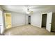 Spacious main bedroom with plush carpet, neutral walls, and multiple entry points at 60 Sweet Bay Ln, Carrollton, GA 30116