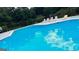 Outdoor pool with multiple lounge chairs and fence surrounding the premises at 60 Sweet Bay Ln, Carrollton, GA 30116