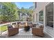 Back deck with ample outdoor seating and a fire pit, perfect for entertaining and relaxing at 4780 Rambling Rose Dr, Cumming, GA 30040