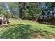 Large backyard with mature trees and lush grass, ideal for outdoor activities and enjoyment at 4780 Rambling Rose Dr, Cumming, GA 30040
