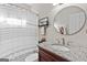 Bathroom vanity with granite countertop and decorative mirror at 4780 Rambling Rose Dr, Cumming, GA 30040