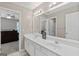 Bright bathroom features a double sink vanity and a large mirror at 4780 Rambling Rose Dr, Cumming, GA 30040