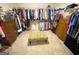 Walk-in closet with extensive shelving and storage, plus a comfy ottoman at 4780 Rambling Rose Dr, Cumming, GA 30040