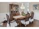 Dining room features elegant chandelier, dining table and decorative china cabinet at 4780 Rambling Rose Dr, Cumming, GA 30040