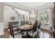 Elegant dining room featuring chandelier, dining table and staircase in background at 4780 Rambling Rose Dr, Cumming, GA 30040
