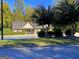 Charming single-story home featuring a well-manicured lawn and mature trees at 4780 Rambling Rose Dr, Cumming, GA 30040