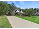 Beautiful two-story home featuring a long driveway, lush lawn, and mature trees at 4780 Rambling Rose Dr, Cumming, GA 30040