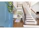 Grand foyer with staircase, hardwood floors, and natural light at 4780 Rambling Rose Dr, Cumming, GA 30040