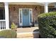 Charming front entrance with stone accents, a welcoming blue door, and a decorative wreath at 4780 Rambling Rose Dr, Cumming, GA 30040