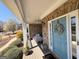 Cozy porch with a swing, stone accents, and charming decor at 4780 Rambling Rose Dr, Cumming, GA 30040