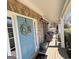 Charming front porch featuring stone accents, a blue door, and comfortable outdoor seating at 4780 Rambling Rose Dr, Cumming, GA 30040