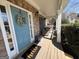 Welcoming porch area with stone siding, outdoor seating, and a 'hello' doormat at 4780 Rambling Rose Dr, Cumming, GA 30040