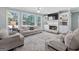 Inviting living room with a cozy fireplace, large windows, and comfortable seating at 4780 Rambling Rose Dr, Cumming, GA 30040