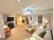 Spacious basement living room with carpet, lighting, and white furniture at 4780 Rambling Rose Dr, Cumming, GA 30040