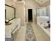 Bright main bathroom features double sink vanity, soaking tub, and glass shower at 4780 Rambling Rose Dr, Cumming, GA 30040