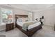 Spacious main bedroom featuring tray ceilings, a large bed, and an exercise bike at 4780 Rambling Rose Dr, Cumming, GA 30040