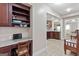 Home office with built-in shelves, desk, and view to kitchen at 4780 Rambling Rose Dr, Cumming, GA 30040