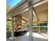 Cozy outdoor living area with stone fireplace, ceiling fans, and comfortable seating at 4780 Rambling Rose Dr, Cumming, GA 30040