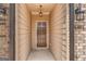 Front entry of townhome with brown door and light-colored walls at 4121 Fulson Dr, Lilburn, GA 30047