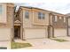 Two-story townhome with attached garage and neutral color brick exterior at 4121 Fulson Dr, Lilburn, GA 30047
