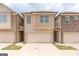 Two-story townhome with attached garage and neutral color brick exterior at 4121 Fulson Dr, Lilburn, GA 30047