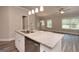 Modern kitchen island with granite countertop and stainless steel dishwasher at 4121 Fulson Dr, Lilburn, GA 30047