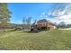 Lush green backyard with expansive lawn and wooded backdrop, ideal for outdoor activities and relaxation on sunny day at 253 Edenwylde Ct, Hampton, GA 30228