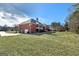 Spacious backyard featuring a covered patio, lush lawn, and mature trees, perfect for outdoor entertaining at 253 Edenwylde Ct, Hampton, GA 30228