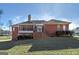 Backyard with a screened porch and deck with lush grass and wooded area, providing a relaxing outdoor setting at 253 Edenwylde Ct, Hampton, GA 30228