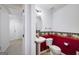 Half bathroom featuring pedestal sink, floral wallpaper, and bright red wall color at 253 Edenwylde Ct, Hampton, GA 30228