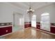 Spacious dining room featuring hardwood floors, large windows, and classic decor, perfect for entertaining at 253 Edenwylde Ct, Hampton, GA 30228