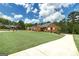Charming two-story red brick home with a well-manicured lawn and a long driveway at 253 Edenwylde Ct, Hampton, GA 30228