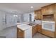 Features wood cabinets, double sinks, a dishwasher and view to breakfast nook at 253 Edenwylde Ct, Hampton, GA 30228