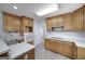 A well-lit kitchen features wood cabinets, modern appliances, and a functional layout at 253 Edenwylde Ct, Hampton, GA 30228