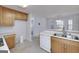 Functional kitchen with wood cabinets, stainless steel double sinks and an open layout at 253 Edenwylde Ct, Hampton, GA 30228