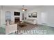 Virtually staged living room with a cozy fireplace and neutral decor, ideal for relaxation and gatherings at 253 Edenwylde Ct, Hampton, GA 30228