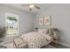 Bright bedroom featuring a cozy queen-sized bed with floral bedding and bedside lamps at 214 Kindness Cir, Mcdonough, GA 30252